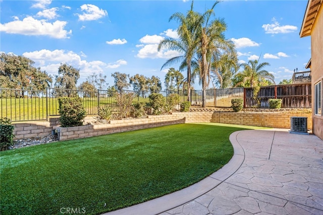 view of yard featuring a patio area and central air condition unit