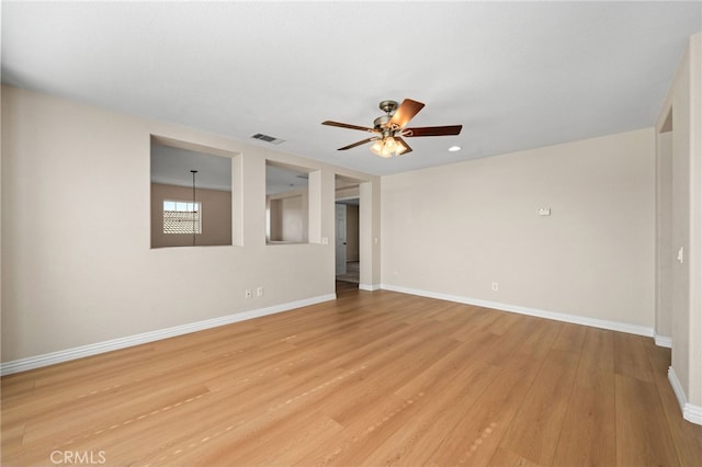 spare room featuring ceiling fan and light wood-type flooring