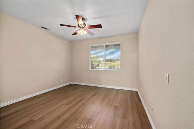 empty room with ceiling fan and wood-type flooring