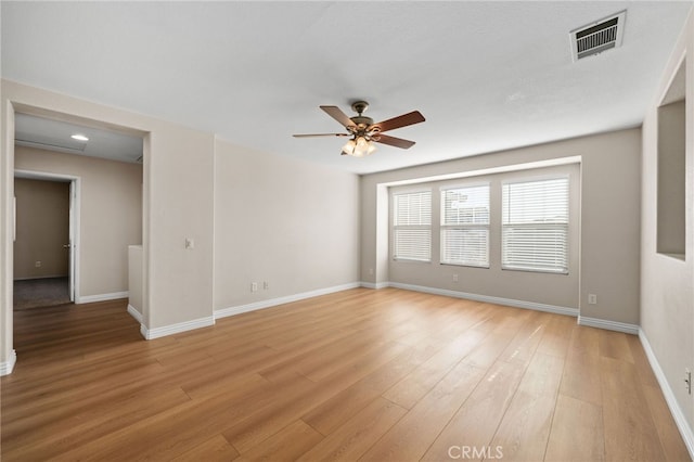 empty room featuring ceiling fan and light hardwood / wood-style flooring