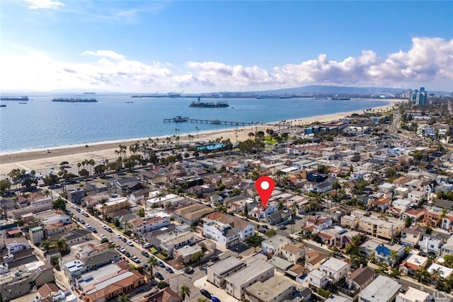 aerial view with a water view and a beach view