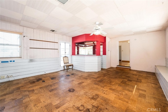 unfurnished living room with ceiling fan