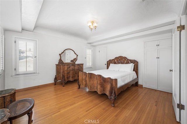 bedroom featuring light hardwood / wood-style floors and multiple windows