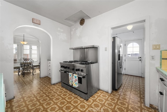 kitchen with white cabinets and appliances with stainless steel finishes