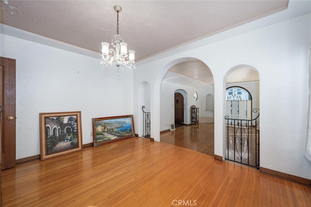 interior space featuring hardwood / wood-style flooring and a chandelier