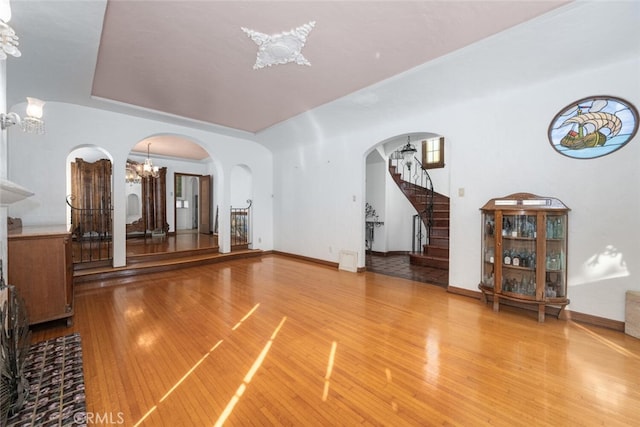 living room with hardwood / wood-style floors, a chandelier, and a tray ceiling