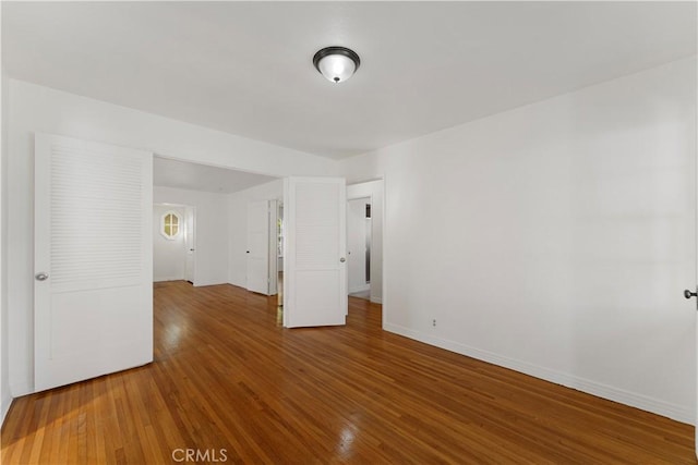 empty room with hardwood / wood-style floors