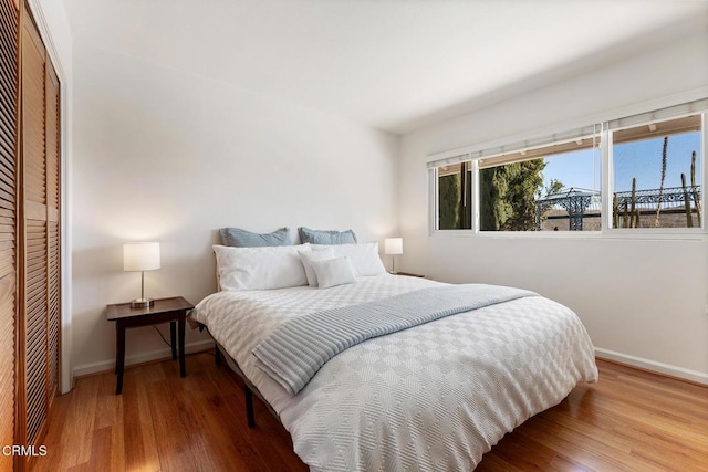 bedroom featuring hardwood / wood-style floors and a closet