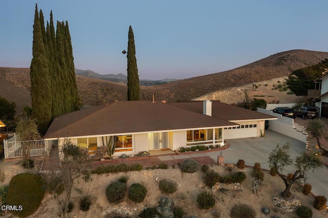 view of front of home featuring a mountain view and a garage