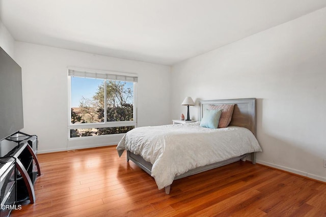 bedroom with hardwood / wood-style floors