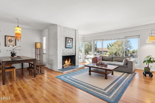 living room with plenty of natural light, hardwood / wood-style floors, and a fireplace