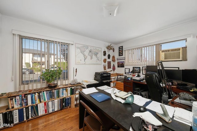 office space with hardwood / wood-style flooring and a wall mounted air conditioner