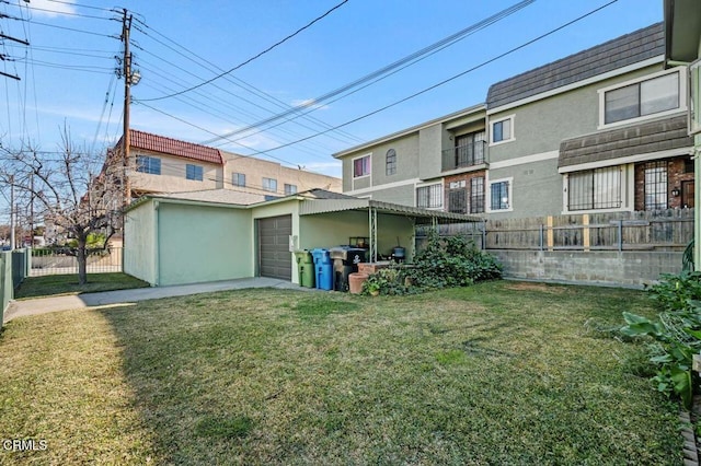 back of house with a lawn and a garage