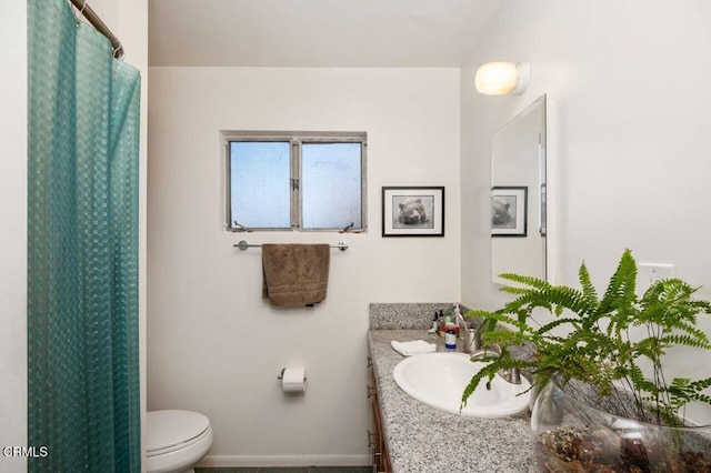 bathroom featuring toilet and vanity