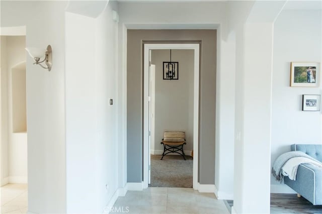 hallway with light colored carpet