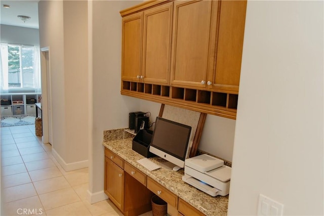 office featuring light tile patterned flooring and built in desk