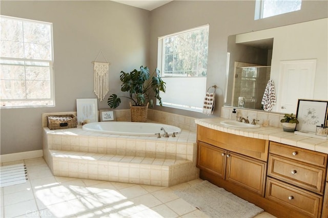 bathroom with a healthy amount of sunlight, plus walk in shower, and tile patterned flooring