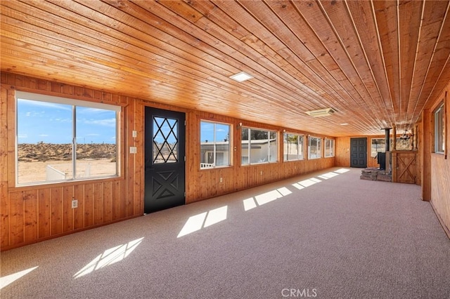 interior space with wood ceiling and wood walls