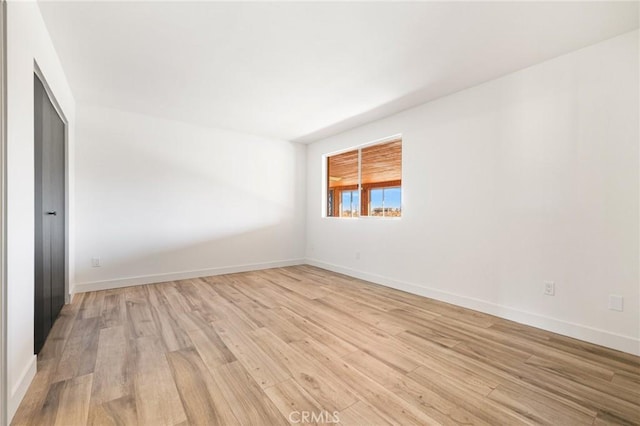 empty room with light hardwood / wood-style floors