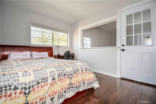 bedroom with dark wood-type flooring