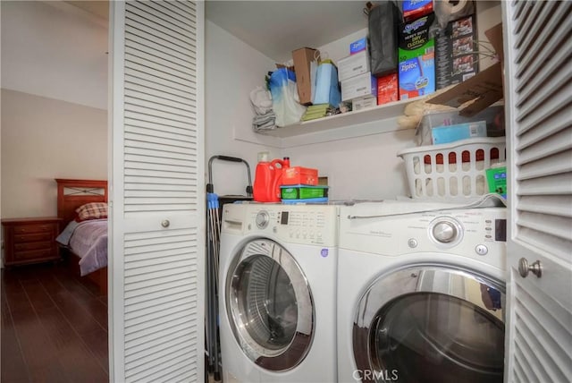 laundry area with dark hardwood / wood-style floors and washing machine and dryer