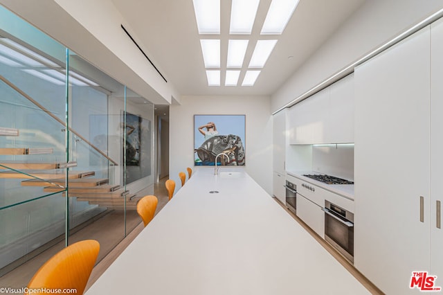 kitchen featuring sink, white cabinetry, and appliances with stainless steel finishes