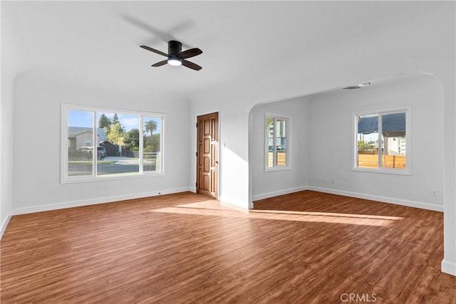 unfurnished living room with wood-type flooring and ceiling fan