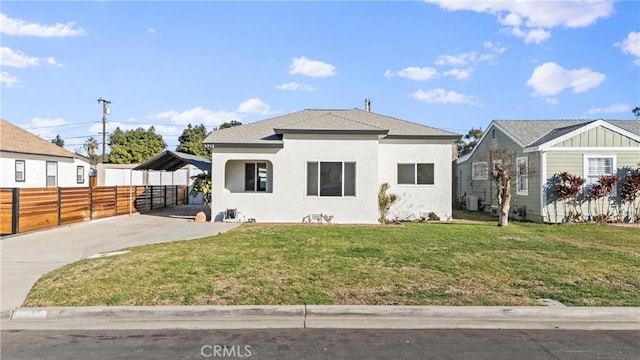 bungalow-style home with a front lawn and a carport