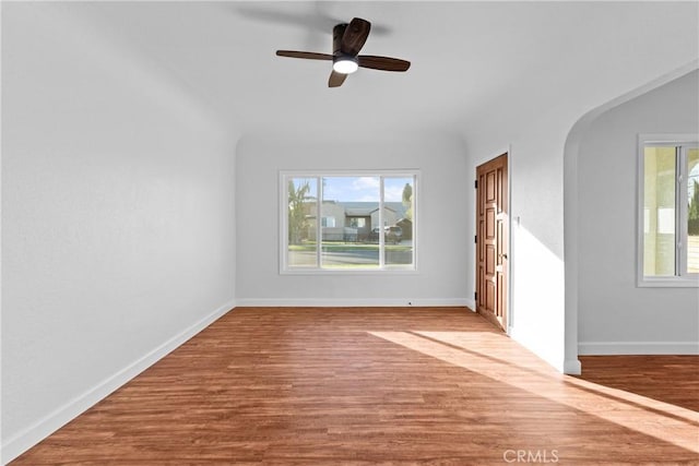 unfurnished living room with ceiling fan and wood-type flooring