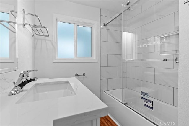 bathroom featuring vanity and shower / bath combination with glass door