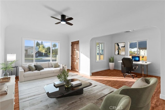 living room featuring hardwood / wood-style flooring and ceiling fan