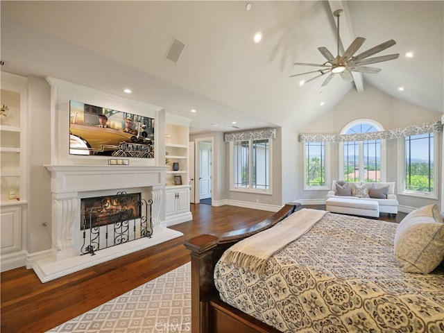 bedroom featuring wood-type flooring, vaulted ceiling with beams, and ceiling fan