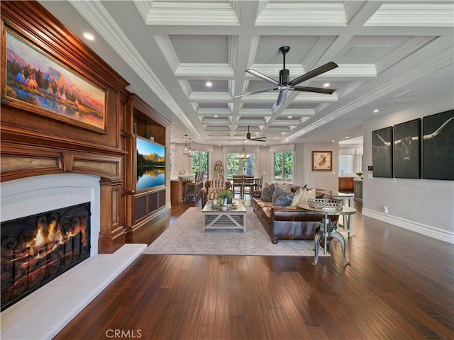 living room with beamed ceiling, crown molding, coffered ceiling, ceiling fan, and dark hardwood / wood-style floors