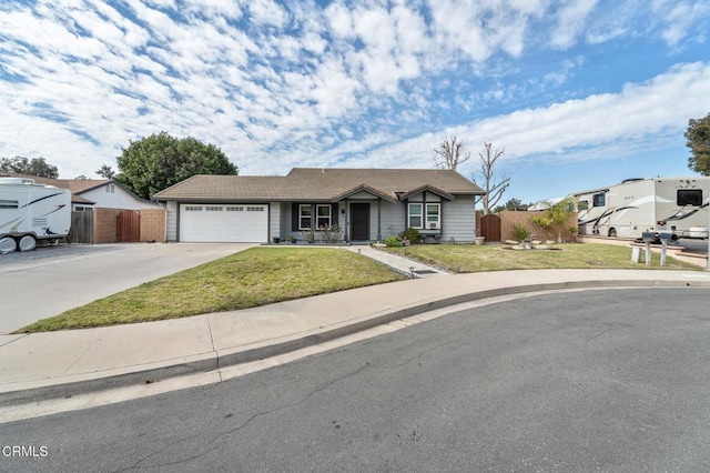 ranch-style home featuring a front yard, concrete driveway, a garage, and fence