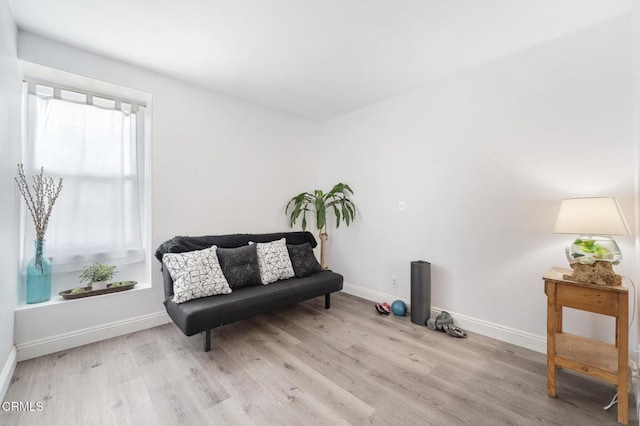sitting room featuring baseboards and wood finished floors