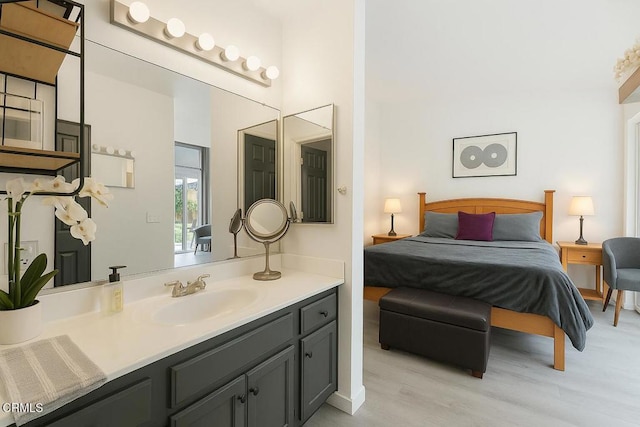 bathroom featuring vanity, wood finished floors, and ensuite bath