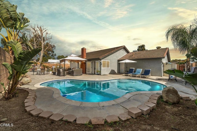view of swimming pool with a fenced in pool, a patio area, and fence