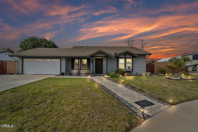 view of front of home featuring fence, a front lawn, a tile roof, a garage, and concrete driveway