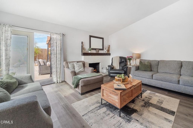 living room with wood finished floors and a fireplace