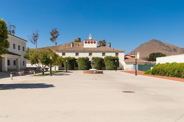 view of property with fence and a mountain view