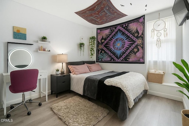 bedroom featuring wood finished floors
