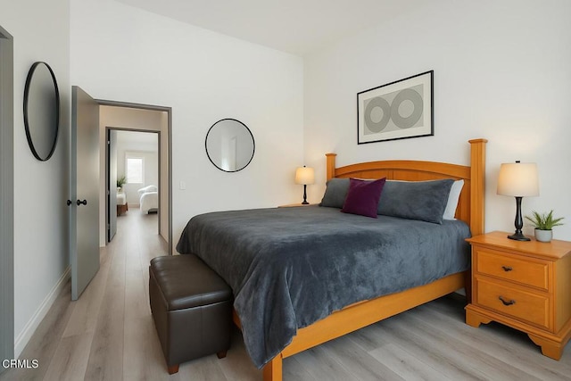 bedroom featuring light wood-style floors and baseboards