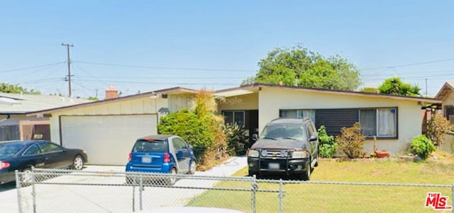 single story home featuring a garage and a front yard