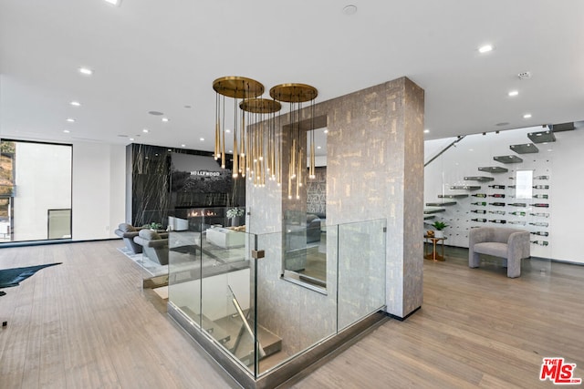 interior space featuring a large fireplace, floor to ceiling windows, and hardwood / wood-style flooring