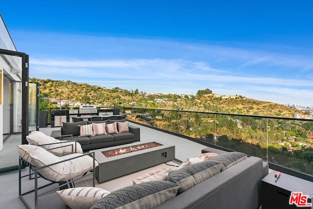 view of patio / terrace featuring an outdoor living space with a fire pit