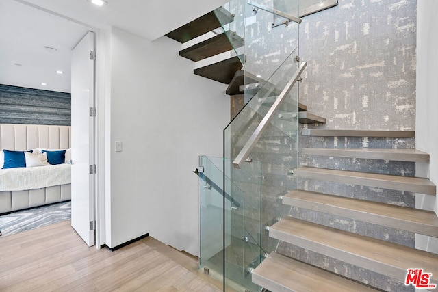 staircase with hardwood / wood-style flooring