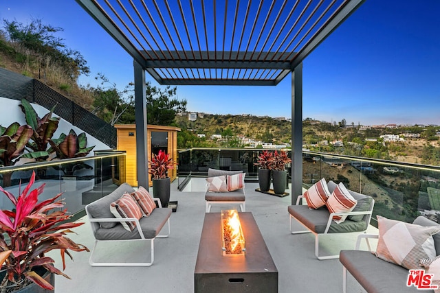 view of patio featuring a pergola and an outdoor living space with a fire pit