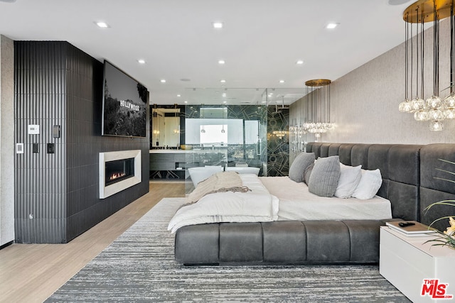 bedroom featuring hardwood / wood-style floors and a fireplace