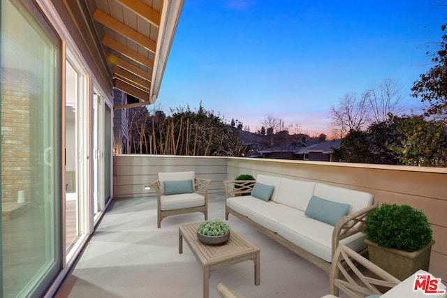 balcony at dusk with an outdoor living space