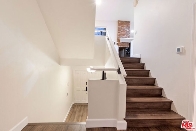 staircase featuring hardwood / wood-style flooring